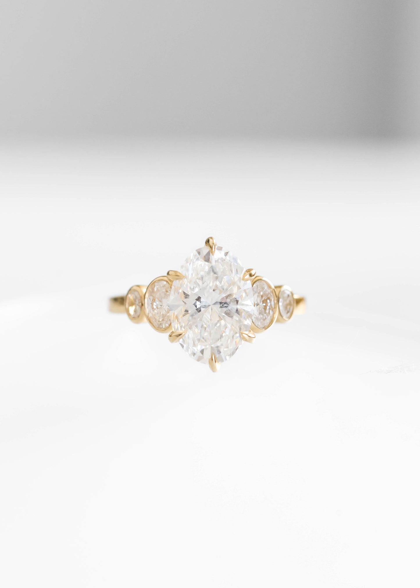 oval lab diamond engagement ring, 14k yellow gold engagement ring, Adelaide setting ring, oval diamond ring, bezel side stone engagement ring, lab grown diamond ring, timeless engagement ring, modern bridal jewelry