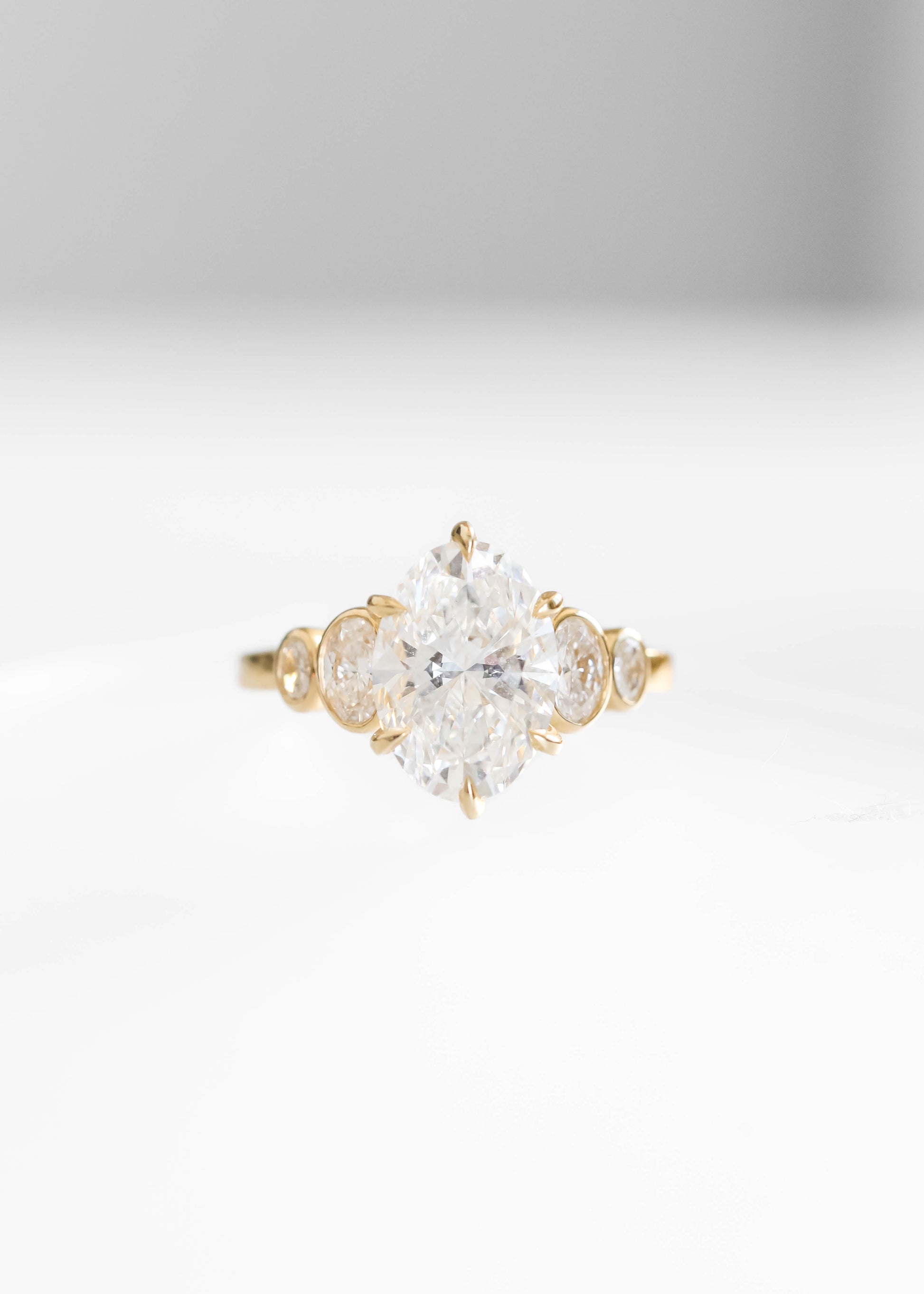 oval lab diamond engagement ring, 14k yellow gold engagement ring, Adelaide setting ring, oval diamond ring, bezel side stone engagement ring, lab grown diamond ring, timeless engagement ring, modern bridal jewelry