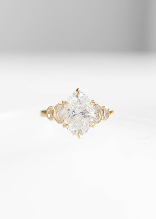 oval lab diamond engagement ring, 14k yellow gold engagement ring, Adelaide setting ring, oval diamond ring, bezel side stone engagement ring, lab grown diamond ring, timeless engagement ring, modern bridal jewelry