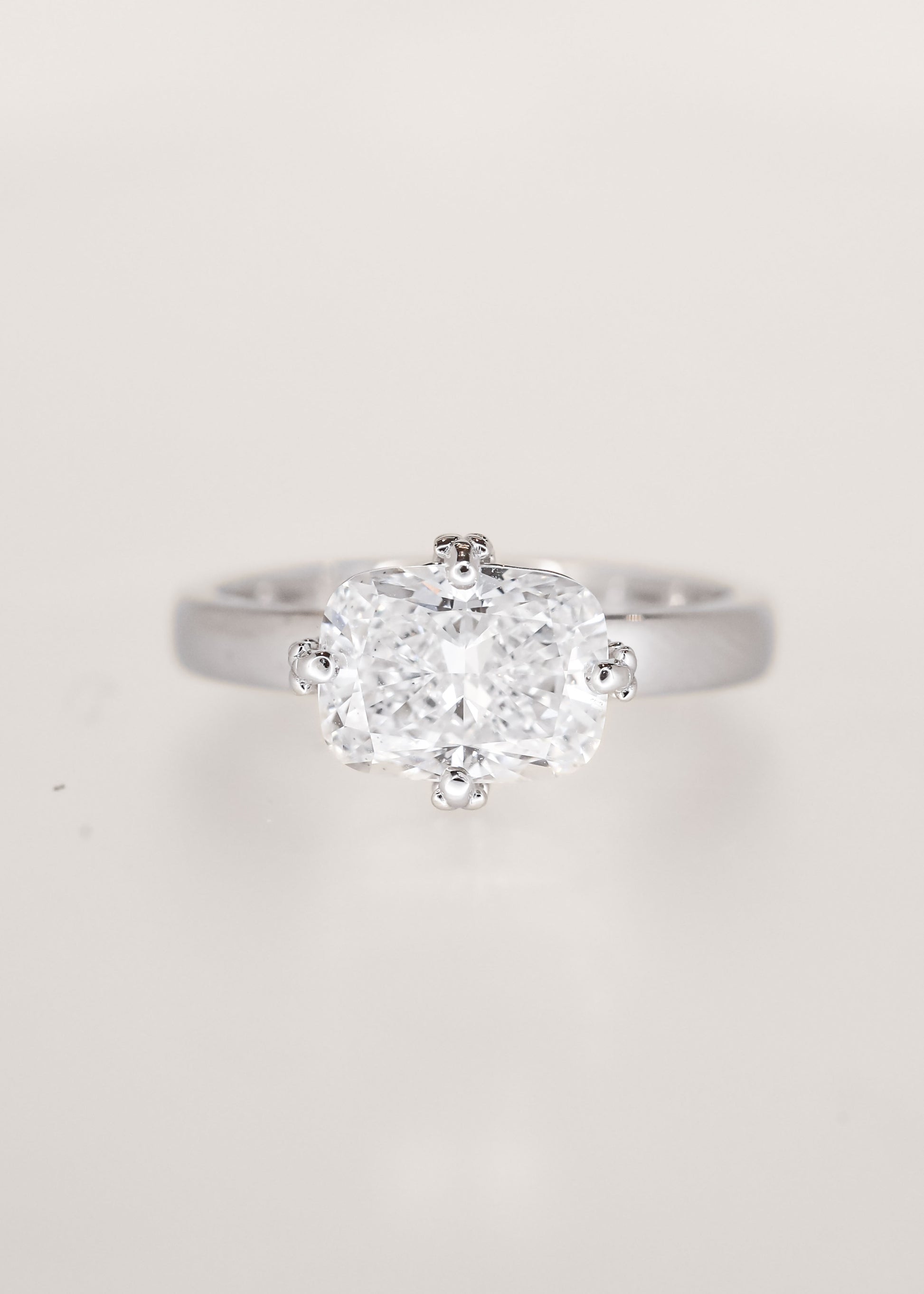 Lavender sprig prong east west elongated cushion lab grown diamond lesbian engagement ring in 14K white gold, pairs with the Greta