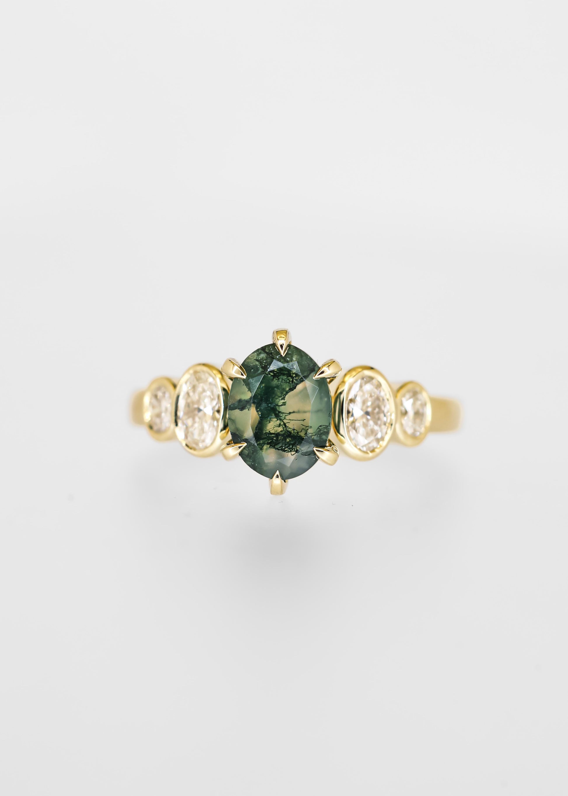 Oval moss agate engagement ring in 14K yellow gold with graduated bezel set oval diamond accent stones