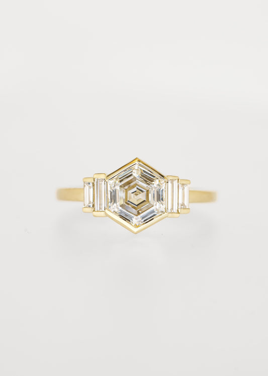 Bezel set hexagon lab grown diamond engagement ring in 14K yellow gold with graduated baguette accent stones