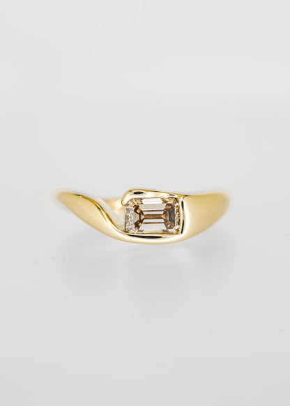 East west bezel set emerald cut champagne diamond engagement ring in 14K yellow gold with a sculptural molten band