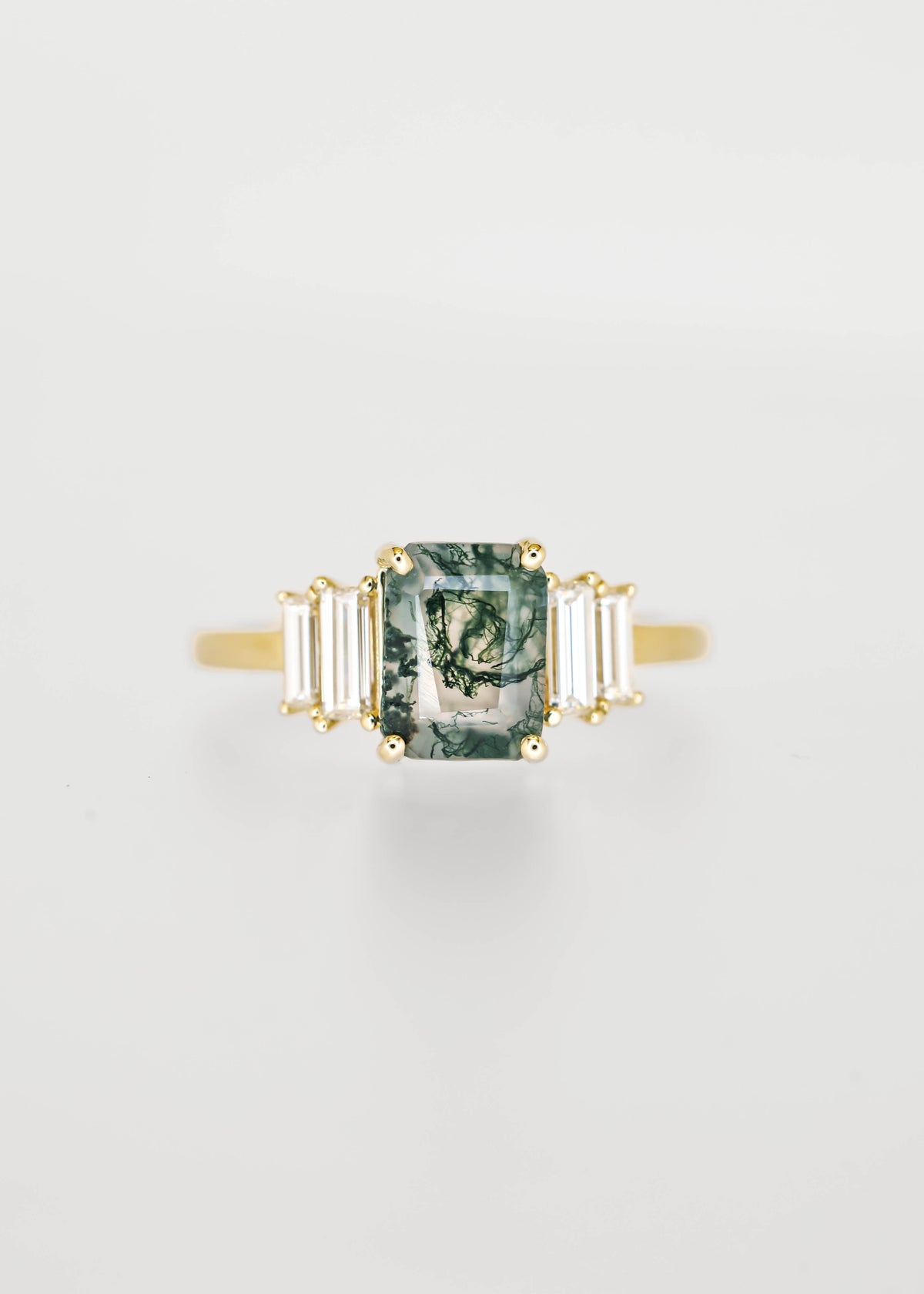 Emerald cut moss agate engagement ring in 14K yellow gold with graduated baguette diamond accent stones