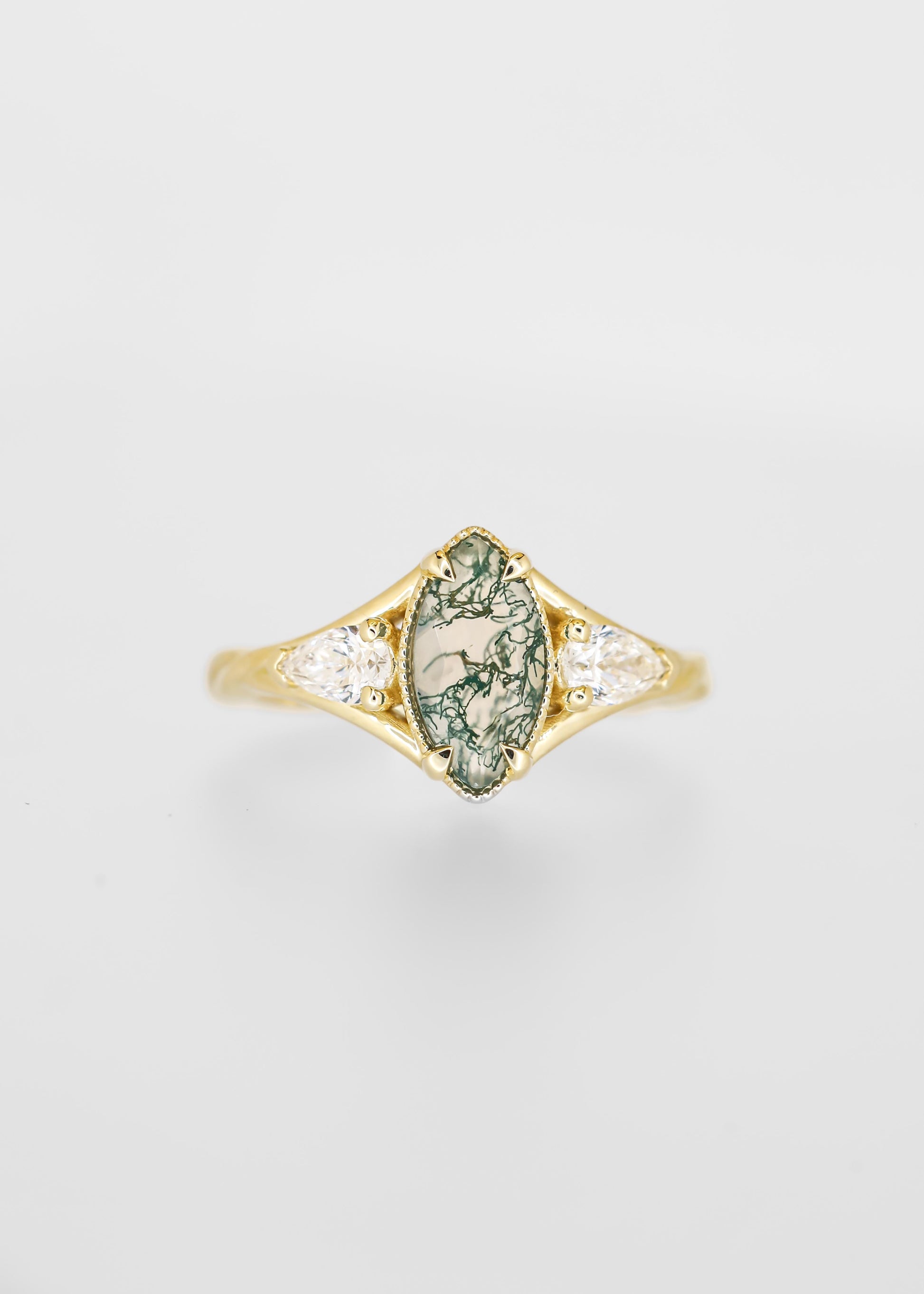 Marquise cut moss agate engagement ring in 14K yellow gold with pear diamond side stones and milgrain detail