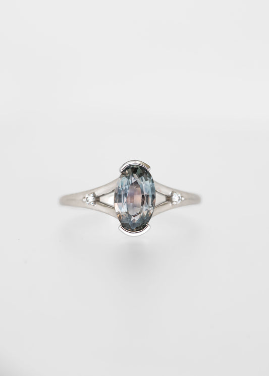 Moval cut grey blue sapphire engagement ring in 14K white gold with a split band and round diamond accents