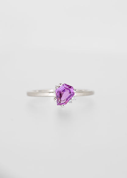 Shield cut pink sapphire engagement ring in 14K white gold with asymmetric round diamond accent stones