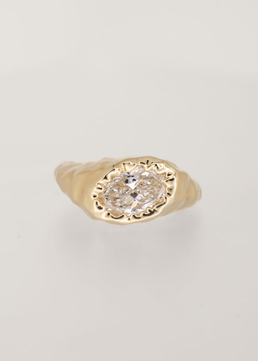 Gender neutral asymmetrical oval lab grown diamond engagement ring in melty 14K yellow gold with an organic drippy bezel setting