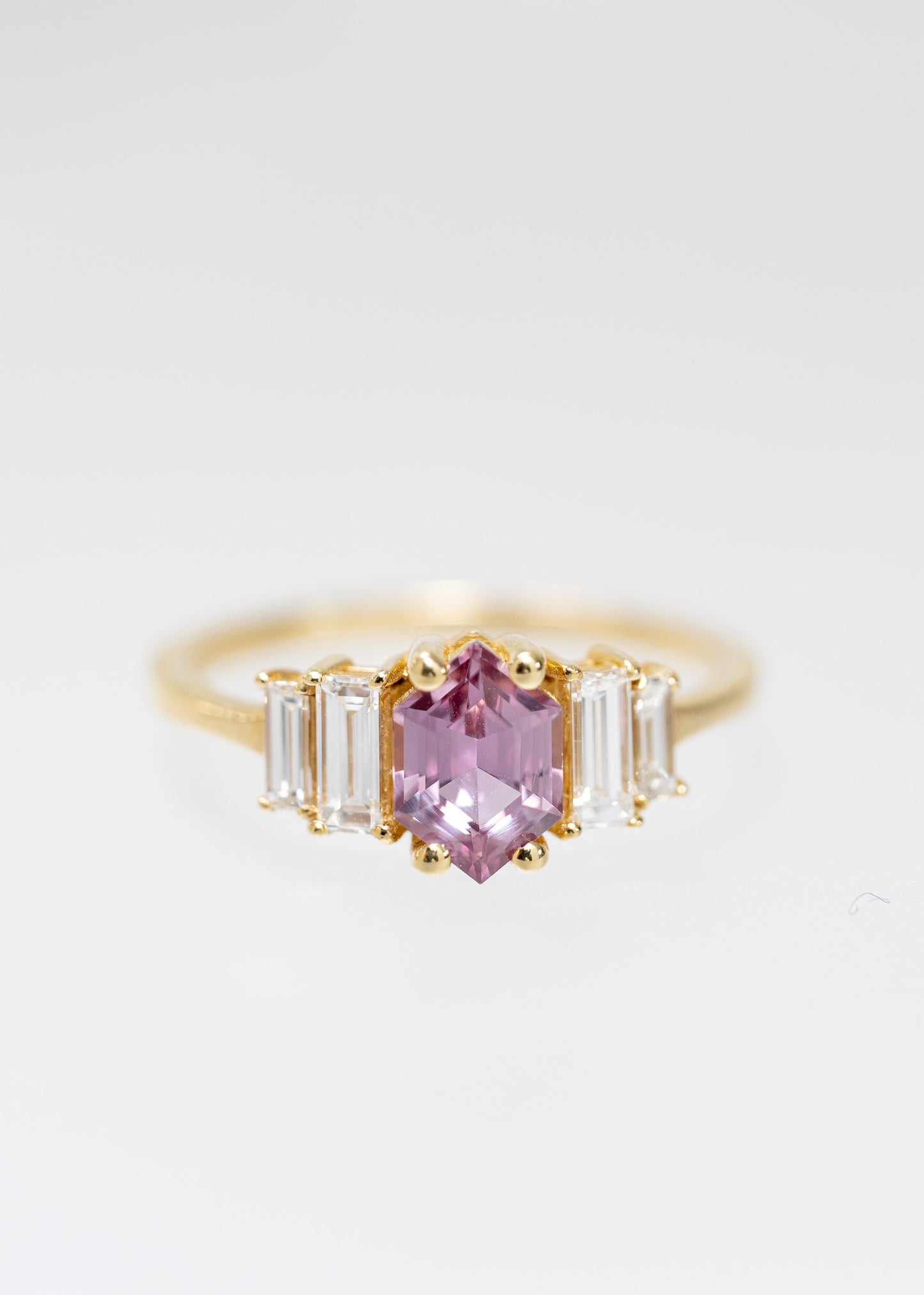 Art Deco hexagon cut pink sapphire engagement ring in 14K yellow gold with graduated baguette side stones
