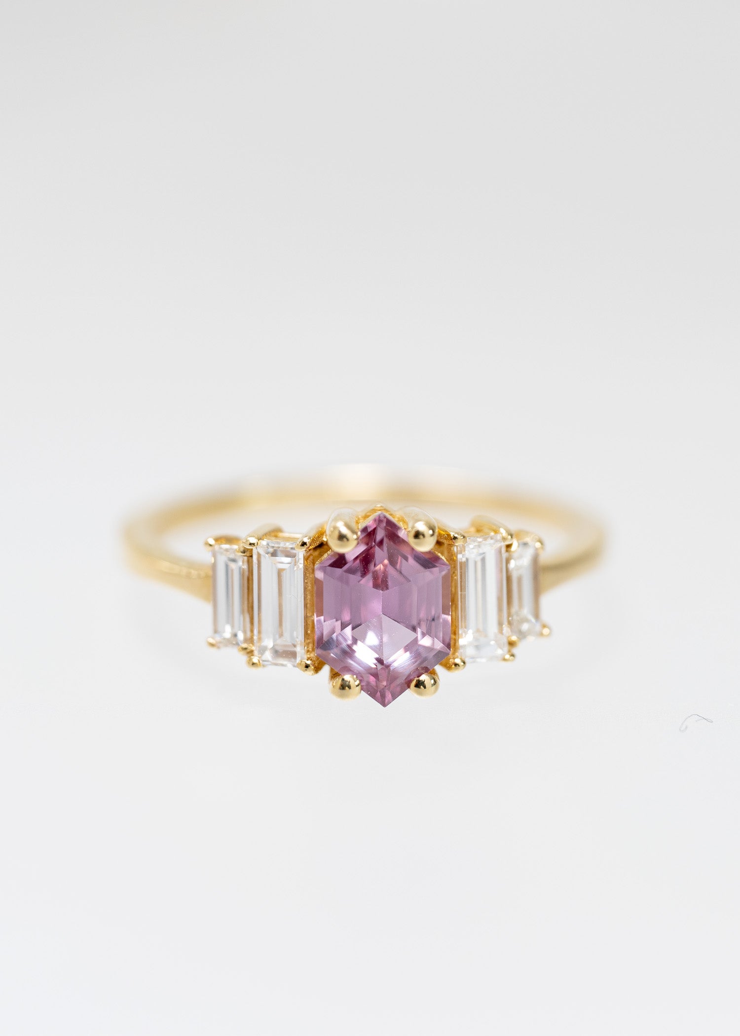 Art Deco hexagon cut pink sapphire engagement ring in 14K yellow gold with graduated baguette side stones