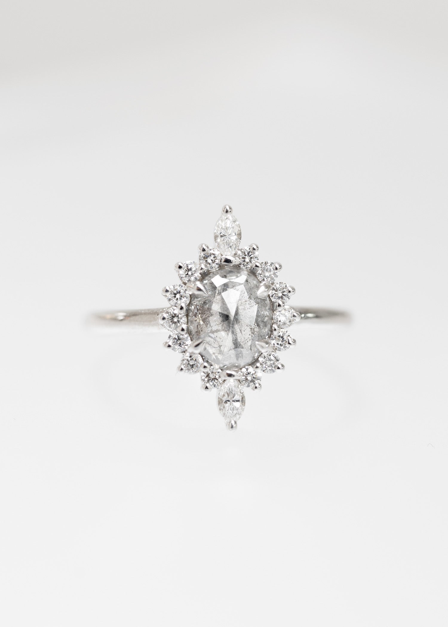Oval salt and pepper diamond starburst halo engagement ring in 14K white gold with marquise diamond accents