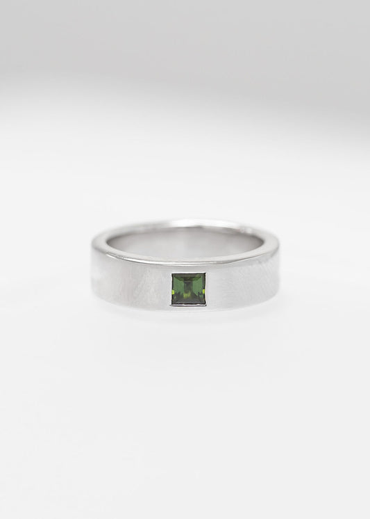 Gender neutral princess cut green tourmaline flush set engagement band in 14K white gold with a wide flat band