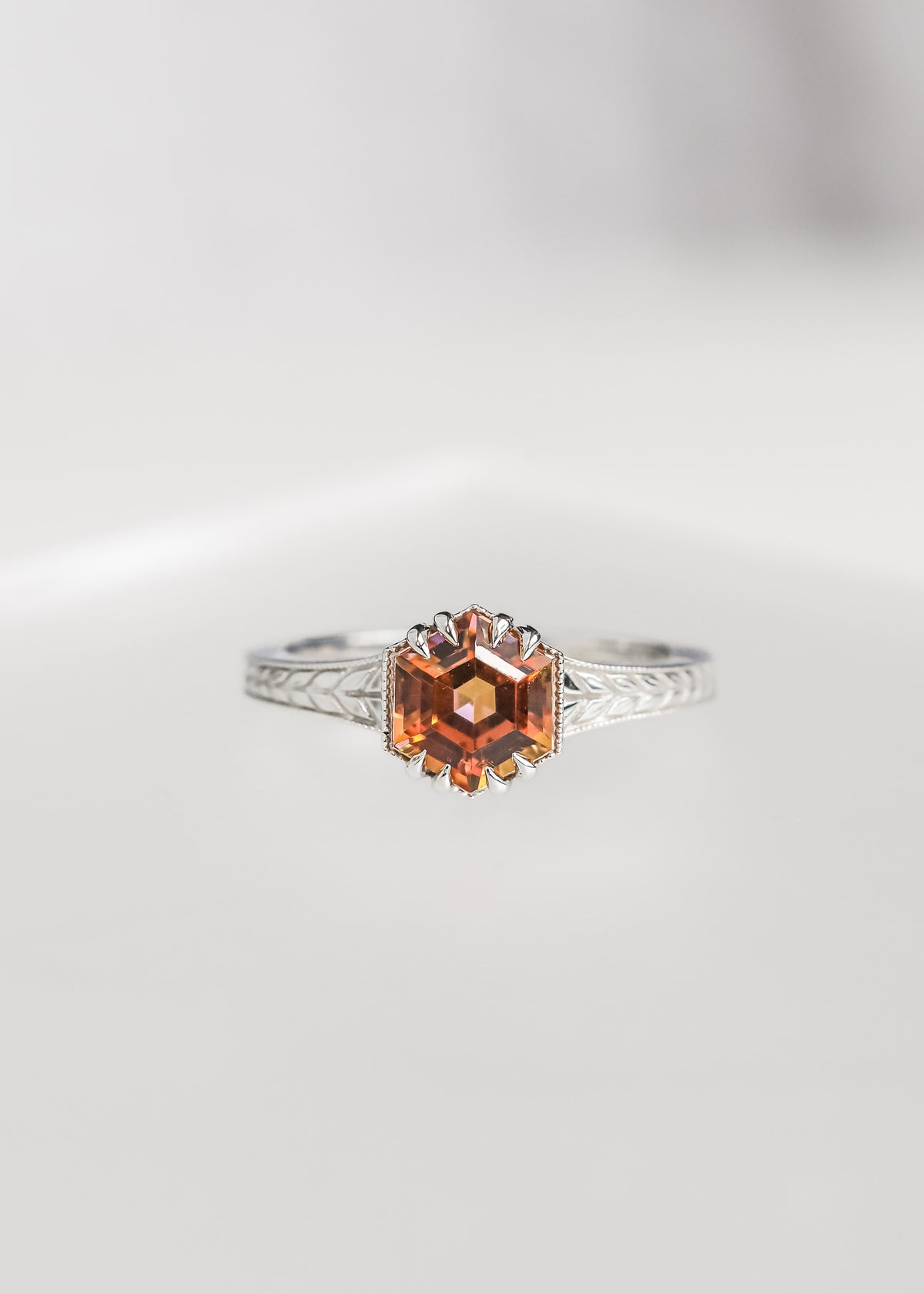 Hexagon cut mystic topaz engagement ring in 14K white gold with milgrain and an engraved wheat band