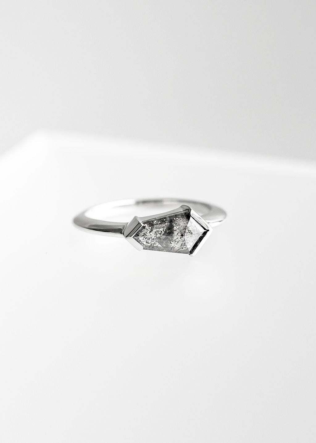 Gender neutral east west kite cut salt and pepper diamond engagement ring in 14K white gold with half bezel setting