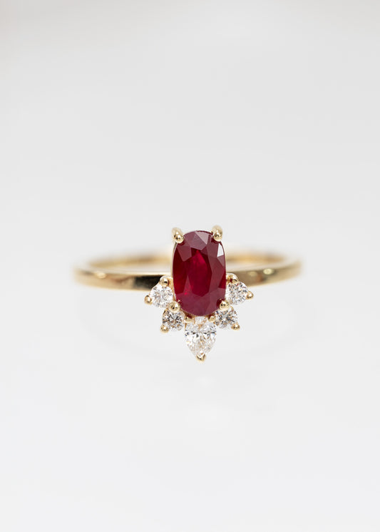 Oval ruby engagement ring in 14K yellow gold with a celestial diamond accent half-halo and pear accent