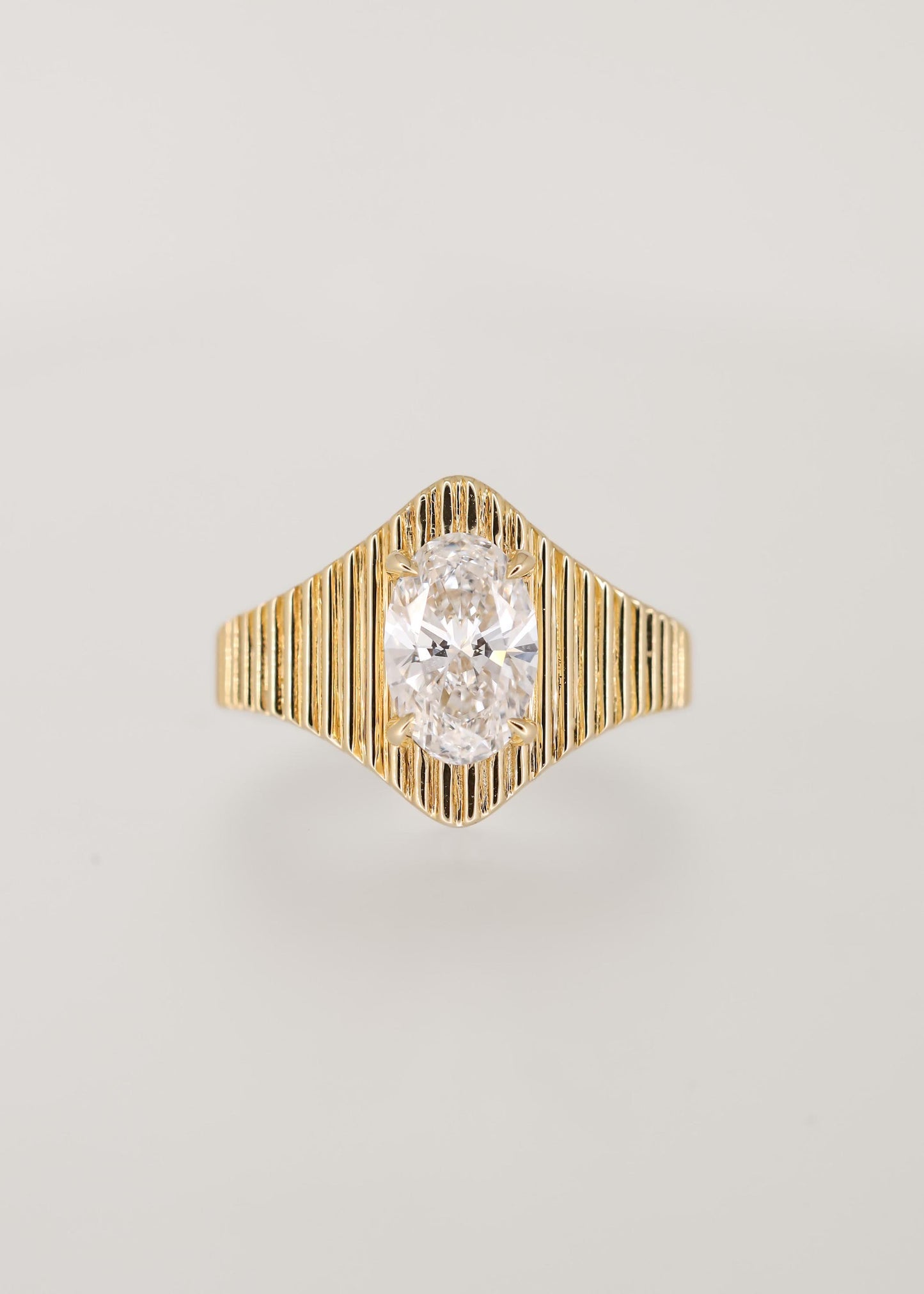 Unique fluted oval cut lab grown diamond signet engagement ring in 14K yellow gold with a four prong north south setting