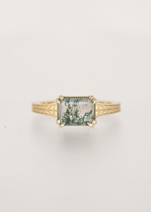 Gender neutral vintage east west emerald cut moss agate engagement ring in 14K yellow gold with milgrain and engraved wheat detailing