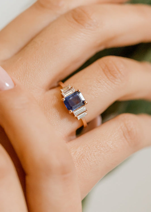 rose gold emerald cut blue sapphire engagement with with four accent baguette diamonds
